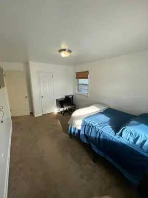 a bedroom with a bed and a desk in it at Cozy Home Near Downtown Rahway in Rahway