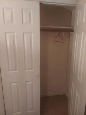 a closet with a white door and a hanger at Deluxe Room A 12 minutes to Ewr in Newark