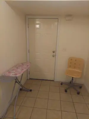 a room with a table and a chair and a door at Deluxe Room A 12 minutes to Ewr in Newark