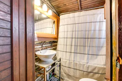 a bathroom with a sink and a shower curtain at Easy Interstate Access Original Poconos Log Cabin in Blakeslee
