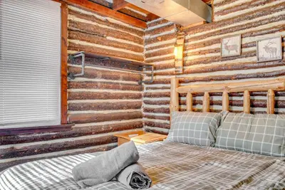 a log cabin bedroom with two beds in it at Easy Interstate Access Original Poconos Log Cabin in Blakeslee