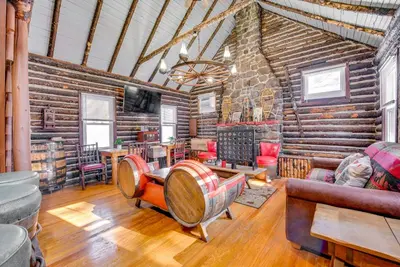 a living room filled with furniture and a wooden wall at Easy Interstate Access Original Poconos Log Cabin in Blakeslee