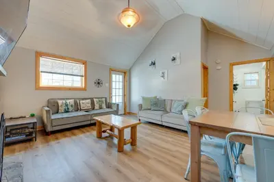 a living room with a couch and a table at 4 Mi to Big Boulder The Cozy Cabin on 8 Acres! in Blakeslee