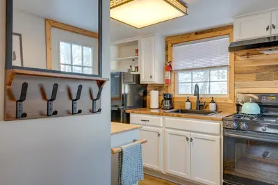a kitchen with white cabinets and a sink at 4 Mi to Big Boulder The Cozy Cabin on 8 Acres! in Blakeslee