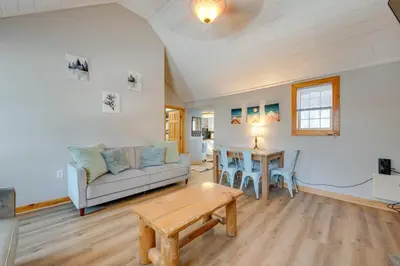 a living room with a couch and a table at 4 Mi to Big Boulder The Cozy Cabin on 8 Acres! in Blakeslee