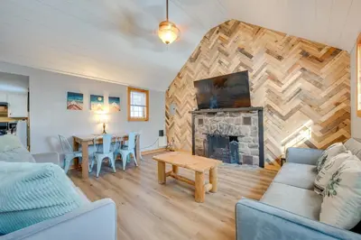 a living room with a fireplace and a table at 4 Mi to Big Boulder The Cozy Cabin on 8 Acres! in Blakeslee