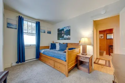 a bedroom with a bed and a window at Private Hot Tub Poconos Babbling Brooke Cottage in Blakeslee