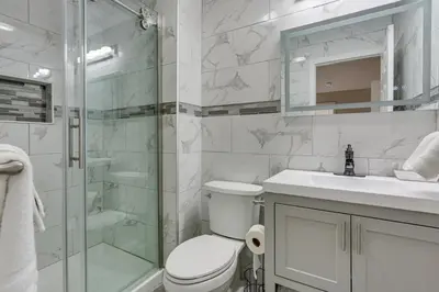 a bathroom with a toilet and a glass shower at East Stroudsburg Townhouse Less Than 1 Mi to Ski Area! in East Stroudsburg