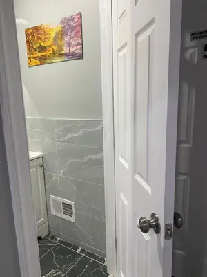 a bathroom with a shower and a picture on the wall at Cozy Getaway Room in Newark