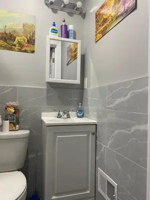 a bathroom with a sink and a toilet at Cozy Getaway Room in Newark