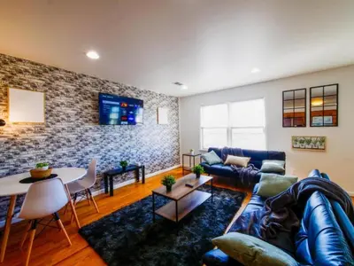 a living room with a couch and a table at Cozy 3 - Bed apartment, Minutes from NYC! in Jersey City