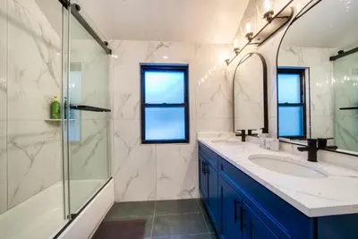 a bathroom with a sink and a glass shower at Brand New House with Huge Patio in Kerhonkson