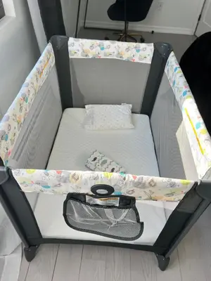 a baby crib with a bed in a room at Brand New House with Huge Patio in Kerhonkson