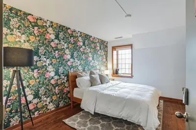 a bedroom with a floral accent wall and a bed at Overlook Brandywine Valley in Thornton