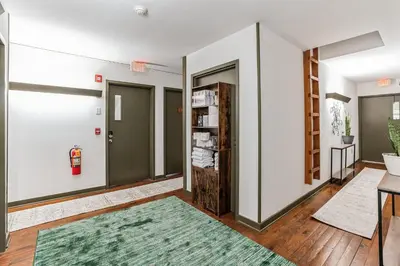 a hallway with two doors and a green rug at Overlook Brandywine Valley in Thornton