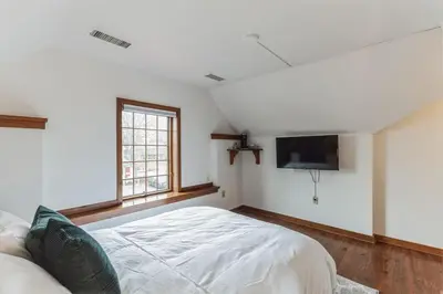 a bedroom with a bed and a flat screen tv at Cozy retreat in Thornton PA in Thornton