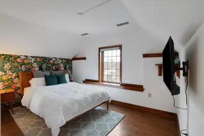 a bedroom with a bed and a flat screen tv at Cozy retreat in Thornton PA in Thornton