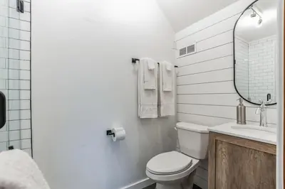 a bathroom with a toilet and a sink and a mirror at Cozy retreat in Thornton PA in Thornton