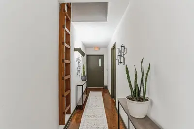 a hallway with white walls and a potted plant at Historic Thornton Studio Retreat in Thornton