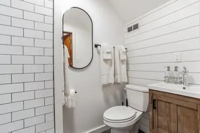 a bathroom with a toilet and a sink and a mirror at Historic Thornton Studio Retreat in Thornton