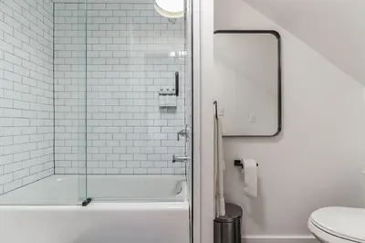 a bathroom with a shower with a glass door at Historic Thornton Studio Retreat in Thornton