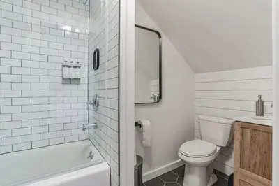 a white bathroom with a toilet and a sink at Historic Thornton Studio Retreat in Thornton