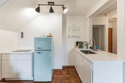 a kitchen with a blue refrigerator and a sink at Thornton Studio with Kitchenette in Thornton