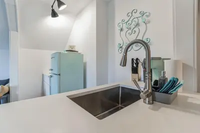a kitchen with a sink and a blue refrigerator at Thornton Studio with Kitchenette in Thornton