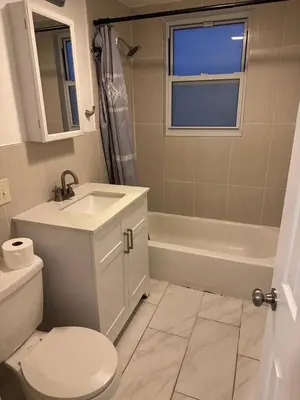 a bathroom with a sink and a toilet and a bath tub at Cozy apartment with city skyline. Easy commute midtown Manhattan. in Jersey City