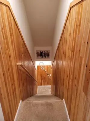 a hallway with wooden walls and a stair case at Luxury 6 BR Rebel Ridge Retreat-Sleeps 16-Hot Tub & Linens Included in Albrightsville