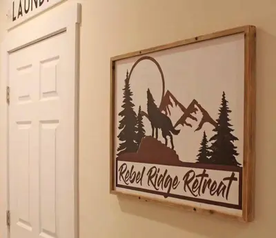 a sign on a wall with a wolf and mountains at Luxury 6 BR Rebel Ridge Retreat-Sleeps 16-Hot Tub & Linens Included in Albrightsville