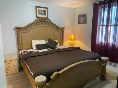 a bedroom with a large bed in a room at King Suite 8Mins to Newark Airport in Newark