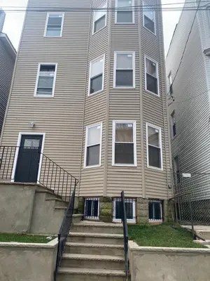 a large house with stairs in front of it at King Suite 8Mins to Newark Airport in Newark