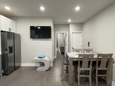 a kitchen and dining room with a table and a refrigerator at Charming 3BR 2BA with Private Patio in Philadelphia
