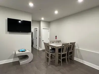 a dining room with a table and chairs and a television at Charming 3BR 2BA with Private Patio in Philadelphia