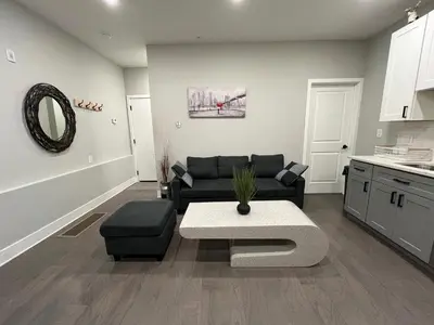a living room with a couch and a table at Charming 3BR 2BA with Private Patio in Philadelphia