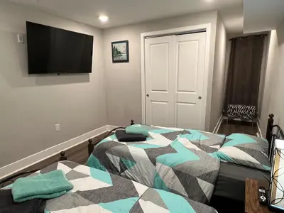 a bedroom with a bed and a flat screen tv at Charming 3BR 2BA with Private Patio in Philadelphia