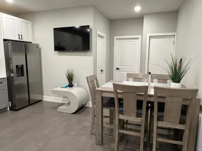 a kitchen with a table and chairs and a refrigerator at Charming 3BR 2BA with Private Patio in Philadelphia