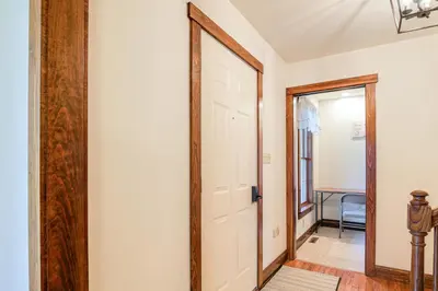 a hallway with a door and a mirror at 4 Mi to the Amish Village Spacious Home with Deck! in Ronks