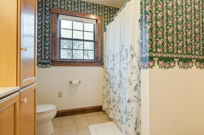 a bathroom with a toilet and a window at 4 Mi to the Amish Village Spacious Home with Deck! in Ronks