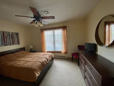 a bedroom with a bed and a ceiling fan at Gorgeous House in Camelback Mountain near lifts! in Tannersville