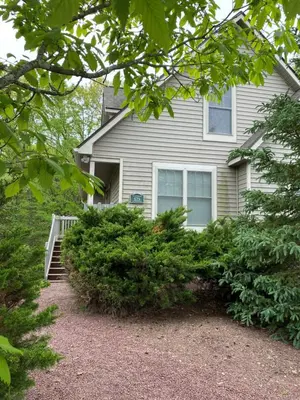 a house with a bunch of bushes in front of it at Gorgeous House in Camelback Mountain near lifts! in Tannersville