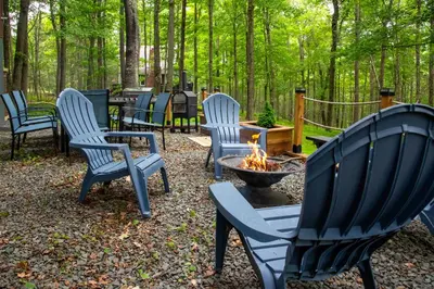 a group of chairs sitting around a fire pit at Family-Friendly Big Bass Lake Vacation Rental! in Gouldsboro