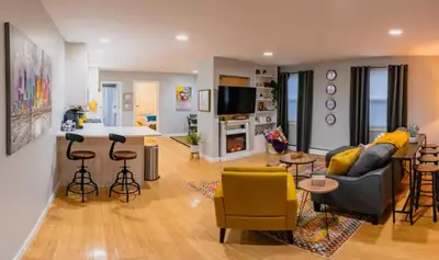 a living room with a couch and a kitchen at New Beautiful Apartment In Bayonne near Subway Path Train Manhattan NYC in Bayonne