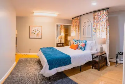 a bedroom with a large bed with a blue blanket at New Beautiful Apartment In Bayonne near Subway Path Train Manhattan NYC in Bayonne