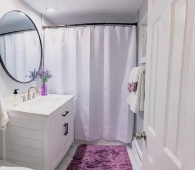 a white bathroom with a sink and a mirror at New Beautiful Apartment In Bayonne near Subway Path Train Manhattan NYC in Bayonne
