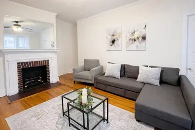 a living room with a couch and a fireplace at Spacious 2-Bedroom Near Elkins Park, Monthly Disco in Elkins Park