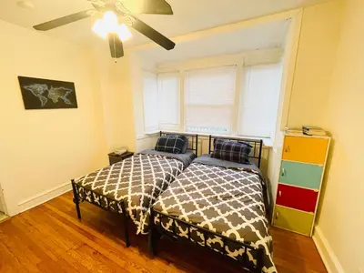 a bedroom with two beds next to a window at Spacious 2-Bedroom Near Elkins Park, Monthly Disco in Elkins Park