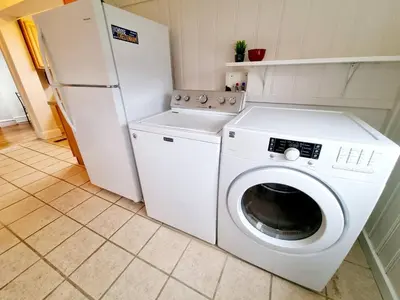a kitchen with a washing machine and a refrigerator at Spacious 2-Bedroom Near Elkins Park, Monthly Disco in Elkins Park