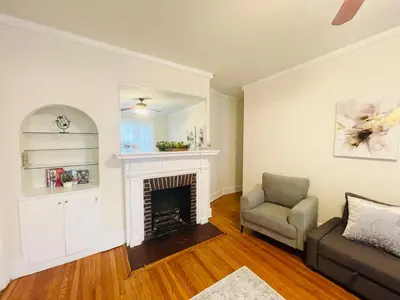 a living room with a chair and a fireplace at Spacious 2-Bedroom Near Elkins Park, Monthly Disco in Elkins Park